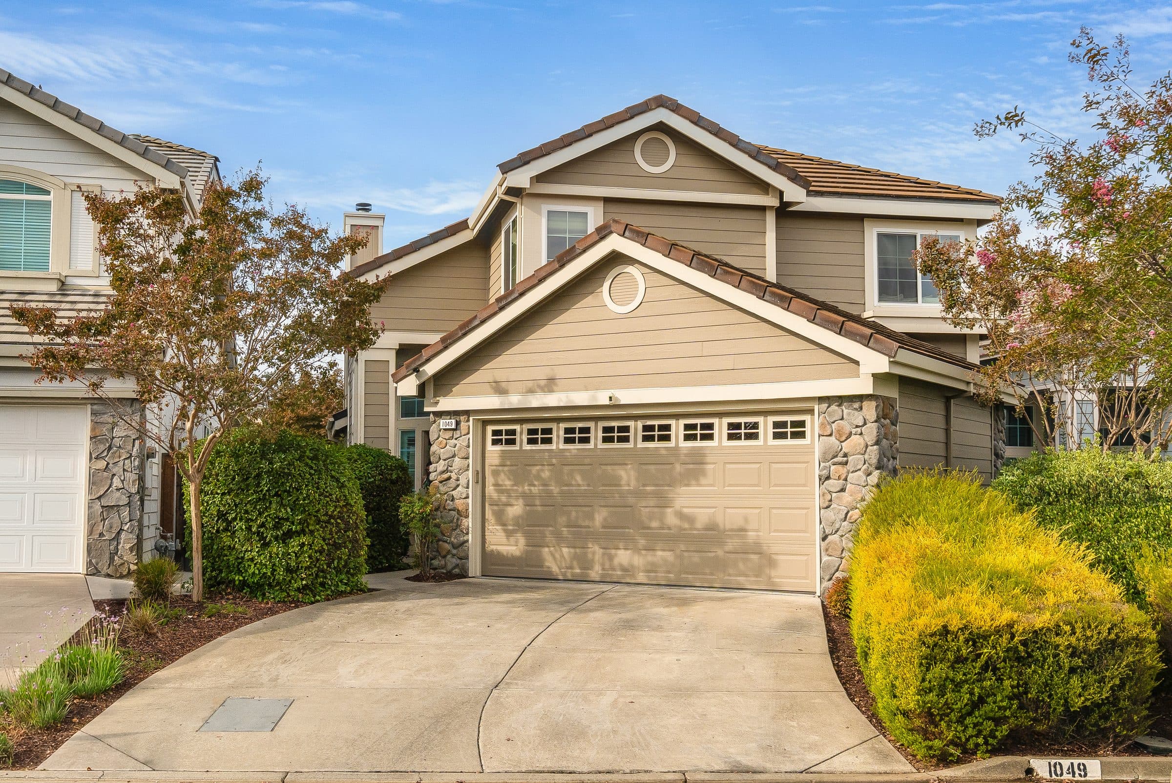 1049 Feather Circle. The front elevation and planted entry walk.