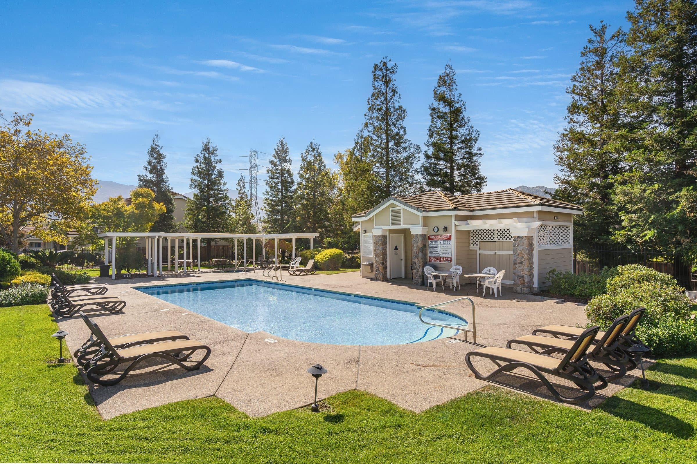 The community pool, with lounge chairs on the lawn.